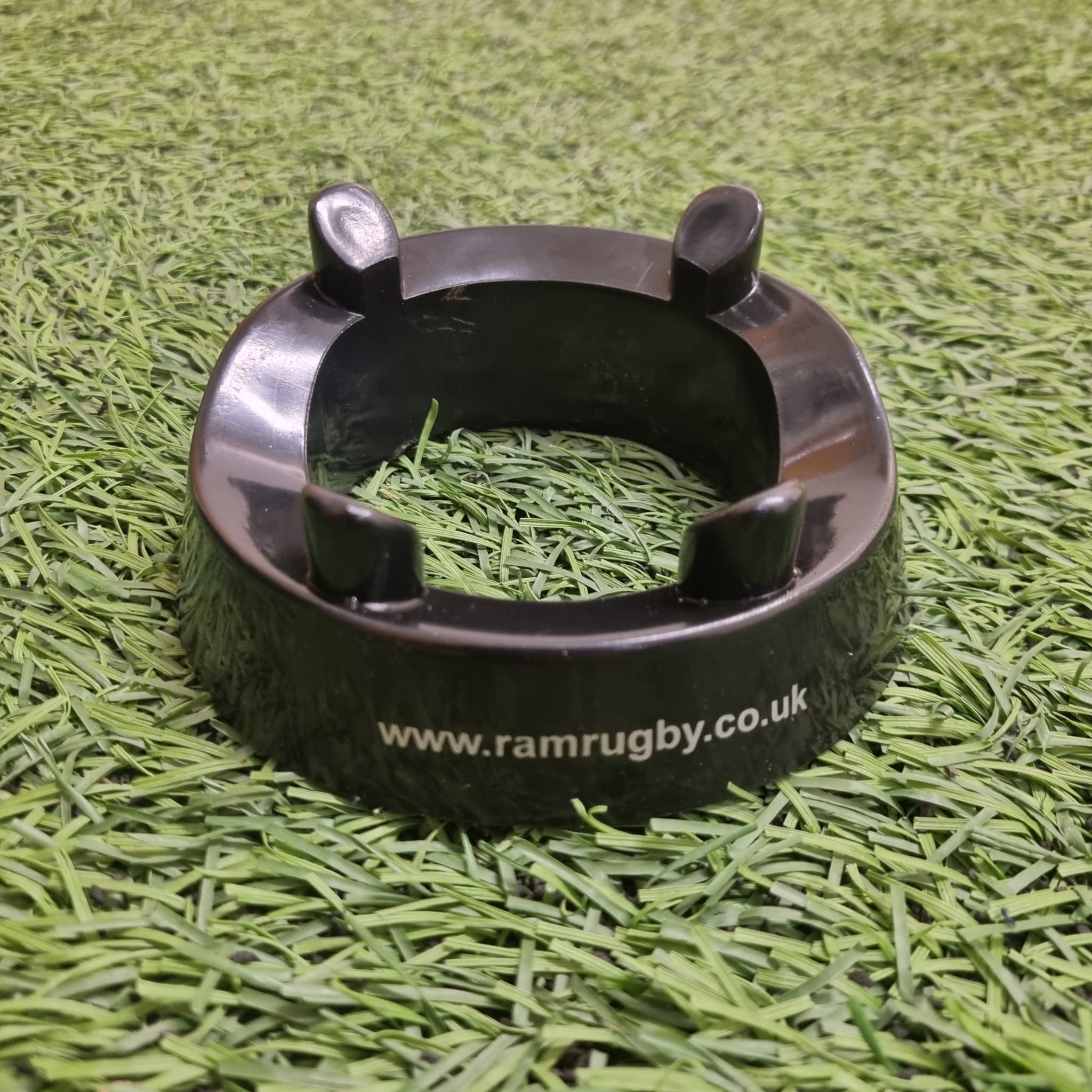 Ram Rugby Black Kicking Tee showing durable molded plastic four-pronged design for stable and consistent kicking support.
