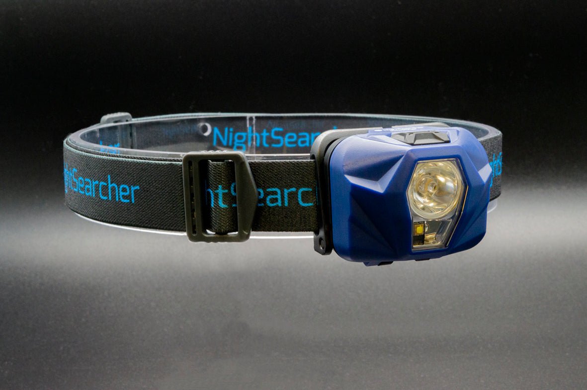 Nightsearcher HeadStar Hybrid Head Torch showing adjustable elastic head strap and compact lightweight design in black and orange