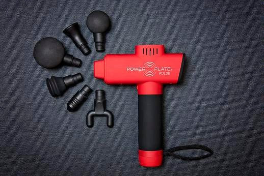 Power Plate Pulse handheld massager in black and gray with ergonomic handle for muscle recovery and fascia release therapy