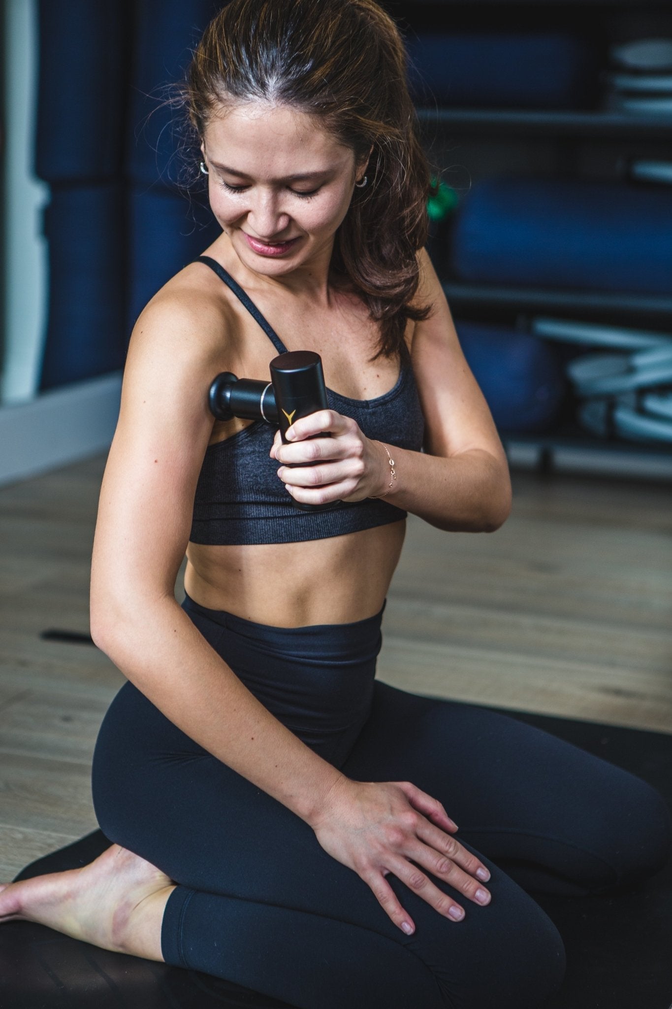 MyoMaster MyoLite Mini Massage Gun in matte black with ergonomic handle, compact design for portable muscle recovery relief