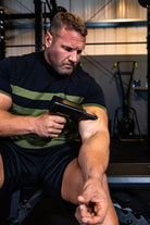 Power Plate MyoPro Massage Gun in black with ergonomic handle and multiple massage heads for muscle pain relief and recovery