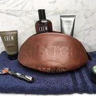 Ram Rugby vintage leather wash bag shaped like a brown rugby ball, hand-stitched with durable, stylish genuine leather